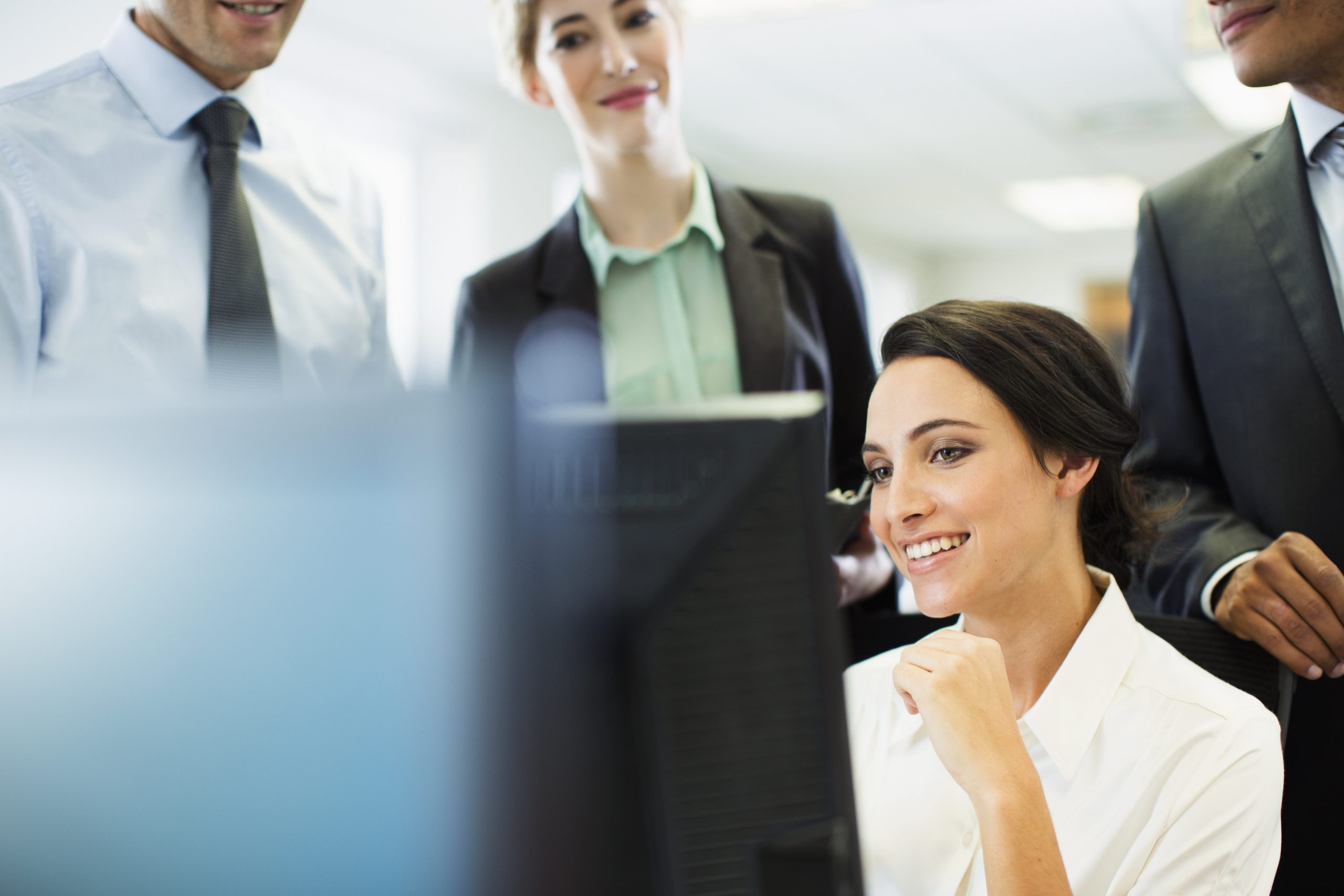 Depiction of businesspeople talking at computer in office